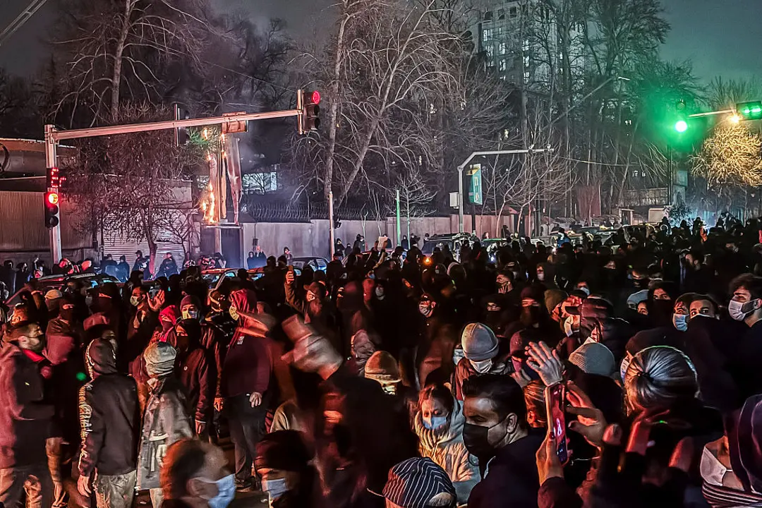 Iranians blocking a street during a protest in Tehran